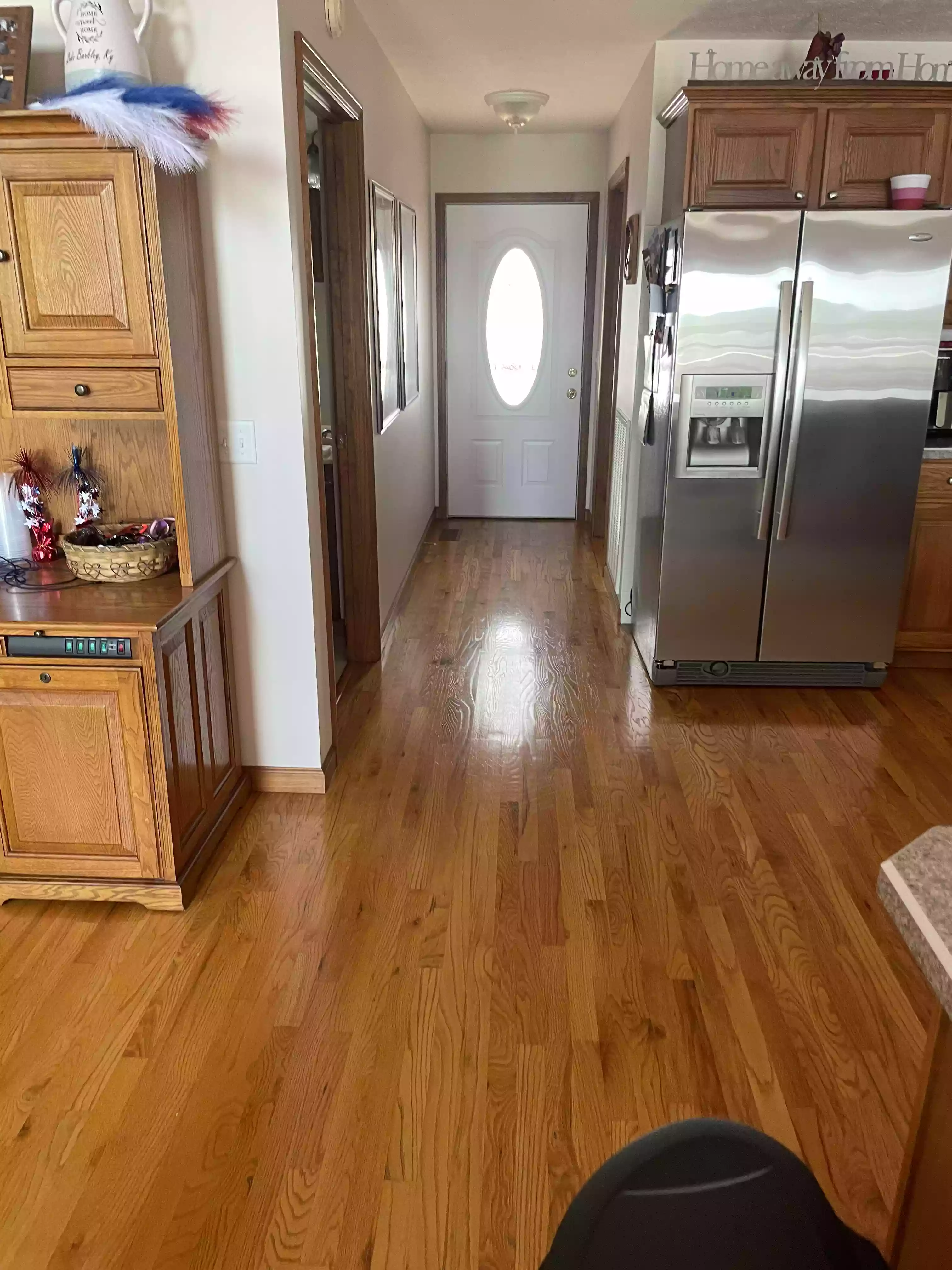 a clean and sparkling entranceway to a home featuring shiny hardwood floors