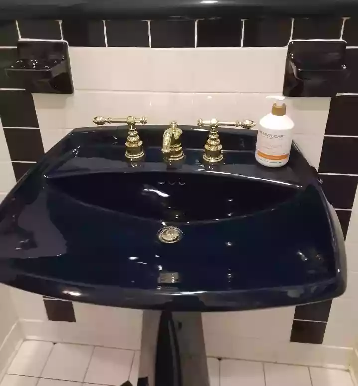 a shiny clean navy blue sink