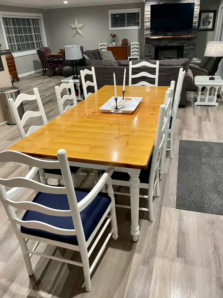 Dining room table and chairs in cozy living room setting.